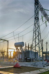 Wall Mural - High voltage electrical transformer at sunset.