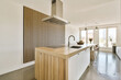 © ADDICTIVE STOCK - Contemporary kitchen with wooden island and sink at home