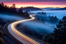 Car Headlights And Traffic Lights On A Winding Road Through Pine Trees, In A Foggy Valley At Sunset, Captured By Long Exposure Photography