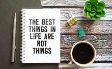 The Best Things In Life Are Not Things - Handwriting On A Napkin With A Cup Of Espresso Coffee.