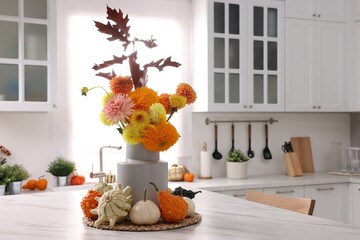 Sticker - Beautiful autumn bouquet and pumpkins on marble table in kitchen