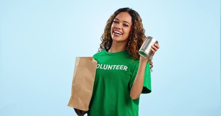 Poster - Volunteer girl, food and donation in studio, smile or face for canned product for ngo by blue background. Woman, bag and happy for giving, care and community service for gift, kindness or portrait