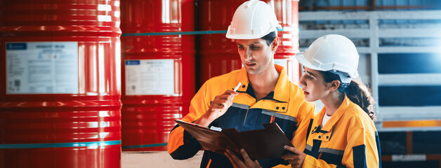 two factory workers or inventory inspector conduct professional inspection on hazardous chemical bar