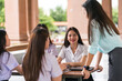 © EduLife Photos - Asian university students meet their education advisor to discuss their academic project outdoor in campus