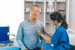 © M+Isolation+Photo - Elderly man engages in thoughtful discussion with compassionate asian people female doctor, addressing health agenda and medical concerns, exemplifying importance of patient-centered care.
