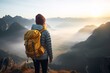 Rear view of young girl traveler with backpack enjoying sunrise on misty mountain peak