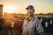 Portrait of smiling mature male farmer standing on cattle farm at sunset