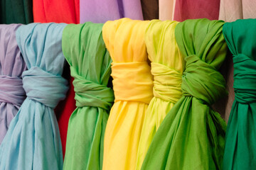 Poster - Mix colorful hanging vertical stripe textile, fabrics, cloths on the rack. Texture of multicolored fabrics close up.