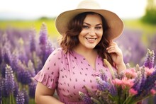 Beautiful Smiling Plus Size Woman In A Straw Hat On Background Purple Lupins Flowers