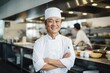 Smiling portrait of an asian chef working in a restaurant kitchen