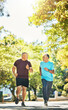 © aLListar/peopleimages.com - Senior, men and running for exercise in road of city for wellness, fitness or workout outdoor with smile. Elderly, people and training together in nature or park for health, adventure and happiness
