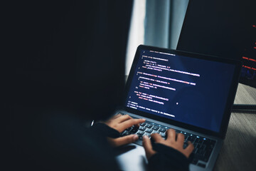 person, hands and hacker on laptop at night in cybersecurity, coding malware or software at home. ha