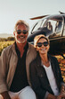 © Nataliya - Happy mature romantic couple posing in front of helicopter. Businessmen flew to their vineyard to check the quality of the harvest
