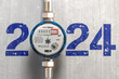 Water meter with 2024 on a wall. Pricing for utilities in the new year 2024 concept.