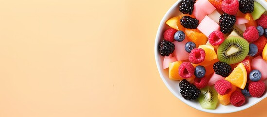 Wall Mural - Fresh fruit salad on pink background from above