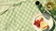 Minimalistic summer picnic setup with wine food and shadowy sunshine on a green pastel backdrop