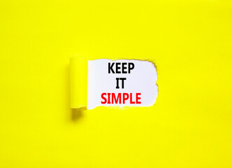 Keep it simple symbol. Concept word Keep it simple on beautiful white paper. Beautiful yellow table yellow background. Business motivational keep it simple concept. Copy space.