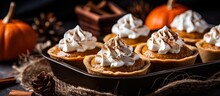 Pumpkin pies with cream and spices baked in a mini muffin tin with copyspace for text