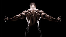 Bodybuilder Demonstrating Impressive Shredded Back Muscles And Showing Thumb's Up In Low-key Photography Style On Back Background