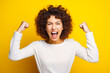 Woman with curly hair is excited about something with her hands.