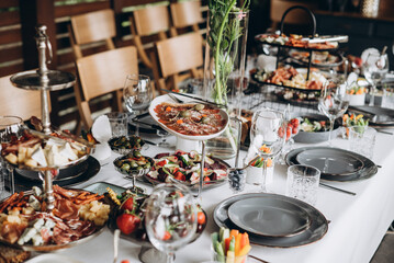 A variety of food on the table, fish, olives, bread, raspberries, meat