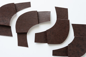 Wall Mural - cut and folded textured dark brown paper with elbow or curved form on white