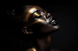 african woman with golden make-up on black background
