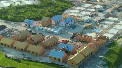 Wall Mural - Aerial view of unfinished wooden frames of affordable houses under construction. Development of residential housing in american suburbs. Real estate market in the USA