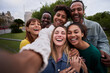 © CarlosBarquero - Cheerful group of friends taking smiling selfie. Group of young people having fun together outdoors at park in the city enjoying travel in vacation holidays.