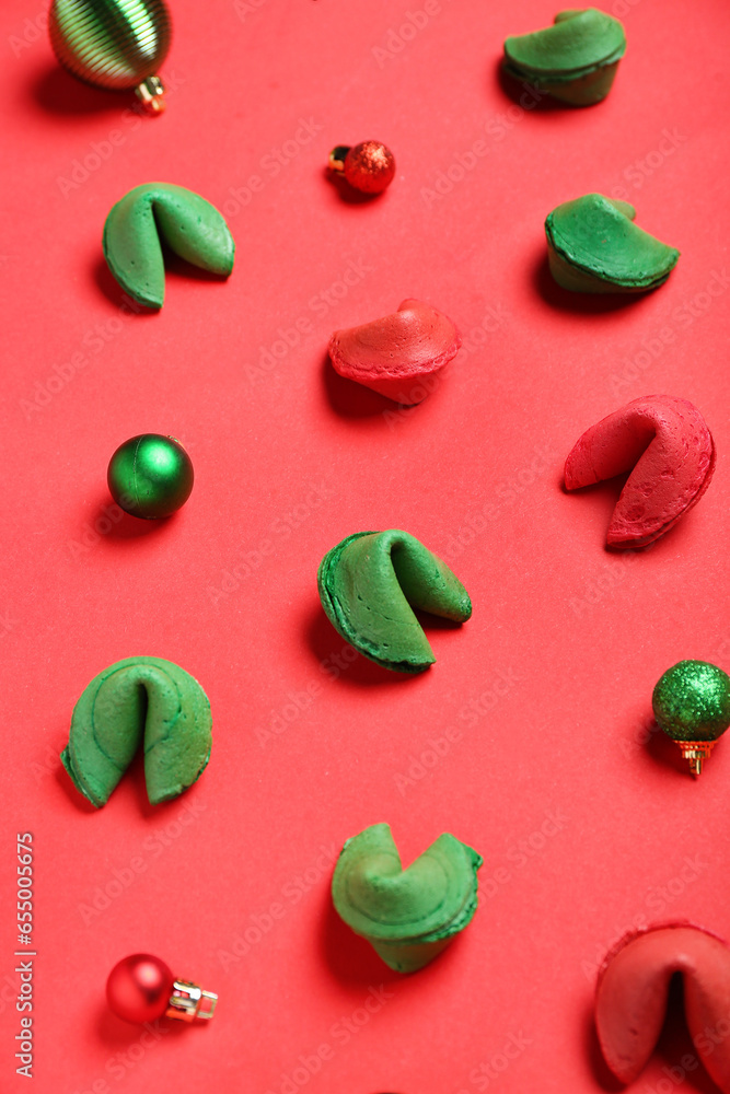 Fortune cookies and Christmas baubles scattered on red background