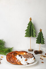 Wall Mural - Plate with tasty Christmas pastry wreath and decorations on light background