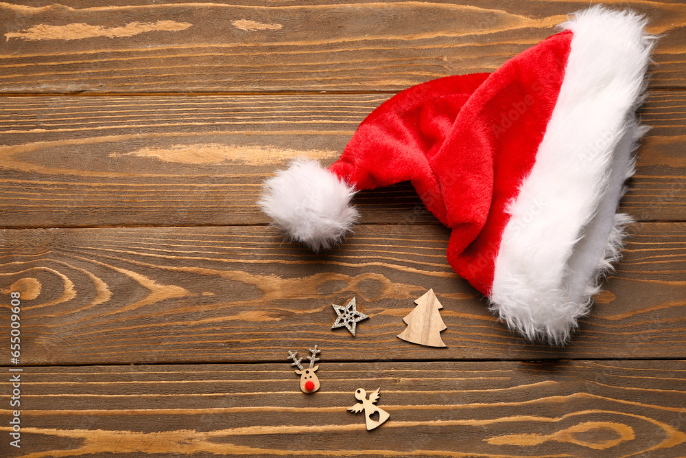 Santa hat with Christmas toys on wooden table