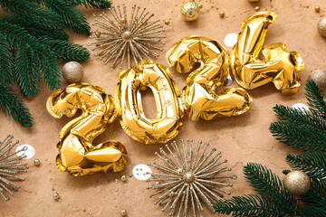 Composition with figure 2024 made of golden foil balloons, beautiful Christmas decorations and fir branches on color background