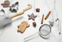 Christmas gingerbread cookies, baking molds and rolling pin on white grunge background