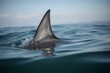 The fin of a shark protruding from the water. Generative AI
