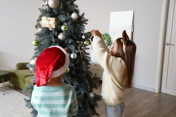 Sticker - Cute little children decorating Christmas tree at home