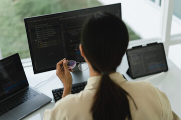 Developer programmer working to checking code on monitor while programming to developing website