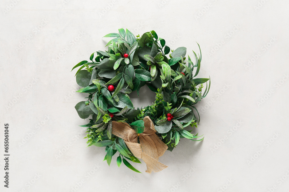 Beautiful mistletoe wreath on white background