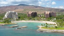 Drone Shot Family Hotel With Scenic Blue Lagoon View. Cinematic Shot On Ko Olina Resorts On Oahu Island Hawaii USA Tourism. Palm Trees Exotic Travel Paradise 4K. Aerial View Of Luxury Beachfront Hotel