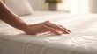 © SaraY Studio  - Woman hand touching soft light mattress