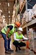 © alfa27 - two men workers doing stocktaking of product management on shelves in warehouse. Physical inventory count. Male professional assistants checking controlling the stock in factory.