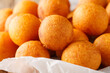 Delicious fried sweet potato and tapioca starch dessert balls close-up on parchment. Horizontal