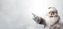 Smiling Santa Claus Pointing At Empty White Advertising Banner Background With Copy Space