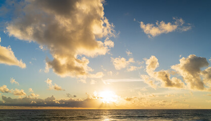 Wall Mural - abstract amazing scene of stuning colorful sunset or sunrise with clouds background in nature and tr