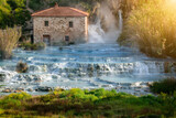 Fototapeta Miasta - Empty natural spa with turquoise water at Saturnia thermal baths, in Tuscany, Italy. Le Cascate del Mulino is a perfect place to relax in waterfalls and hot springs.
