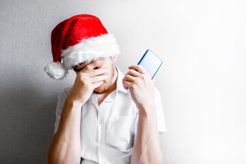 Wall Mural - Sad Young Man in Santa Hat