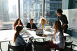 © fizkes - African American business people team brainstorming at corporate meeting, discussing financial project strategy or market research result, employees entrepreneurs business partners negotiating