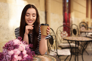 Poster - Beautiful woman with bouquet of spring flowers and coffee in outdoor cafe, space for text