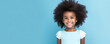 portrait of a young smiling girl with afro on blue background