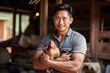 © Attasit - Asia Farmer man smiling looking at camera working in a chicken bag. modern farmer use tablet working in farm